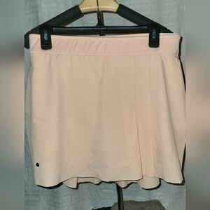 NWT Nike golf/tennis skort.  Pretty peach color.  2 side pockets and 1 back